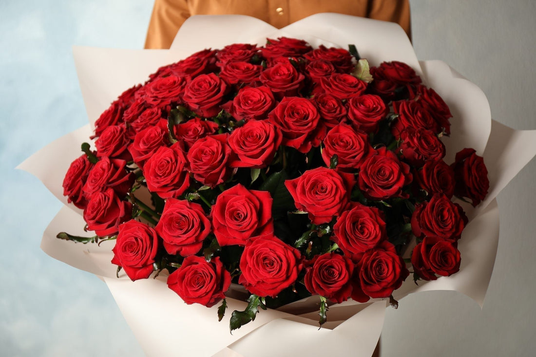 Person holding an abundant red rose bouquet in Singapore, chosen to express a meaningful and romantic statement.