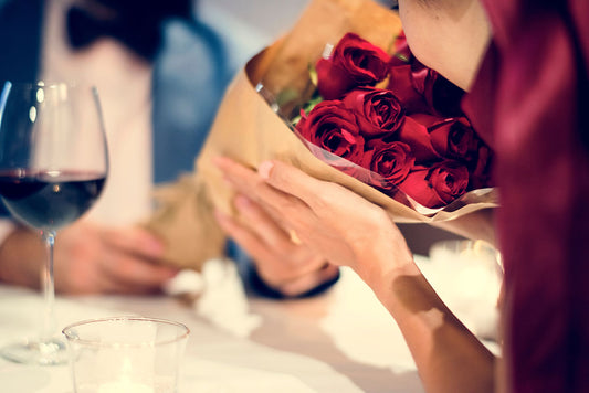 Close-up of a recipient holding a bouquet of red roses, encapsulating Valentine’s Day romance.